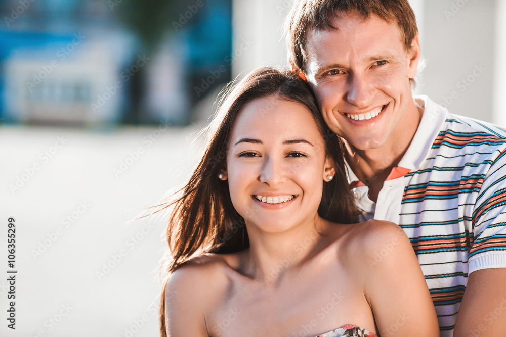 The guy embraces his girlfriend during a walk in the fresh air The guy embraces his girlfriend during a walk in the fresh air