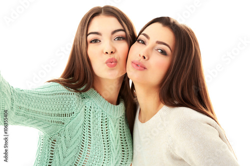 Two teenager girls making p...
