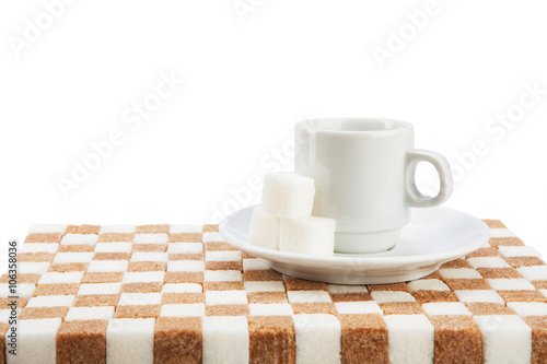 Empty coffee cup on a saucer with three cubes of sugar on a stan