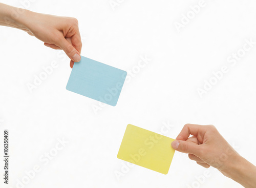 Human hands holding colorful paper cards