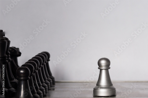 Light and dark wooden chess pieces on chess table.