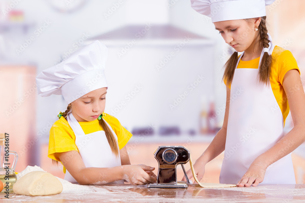 Children make the dough in the kitchen, roll a rolling pin Children make the dough in the kitchen, roll a rolling pin