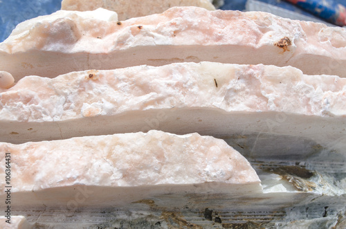 Slicing long strips of pink onyx for handling 