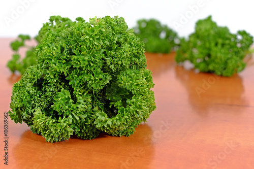 Curly parsley on a wooden table