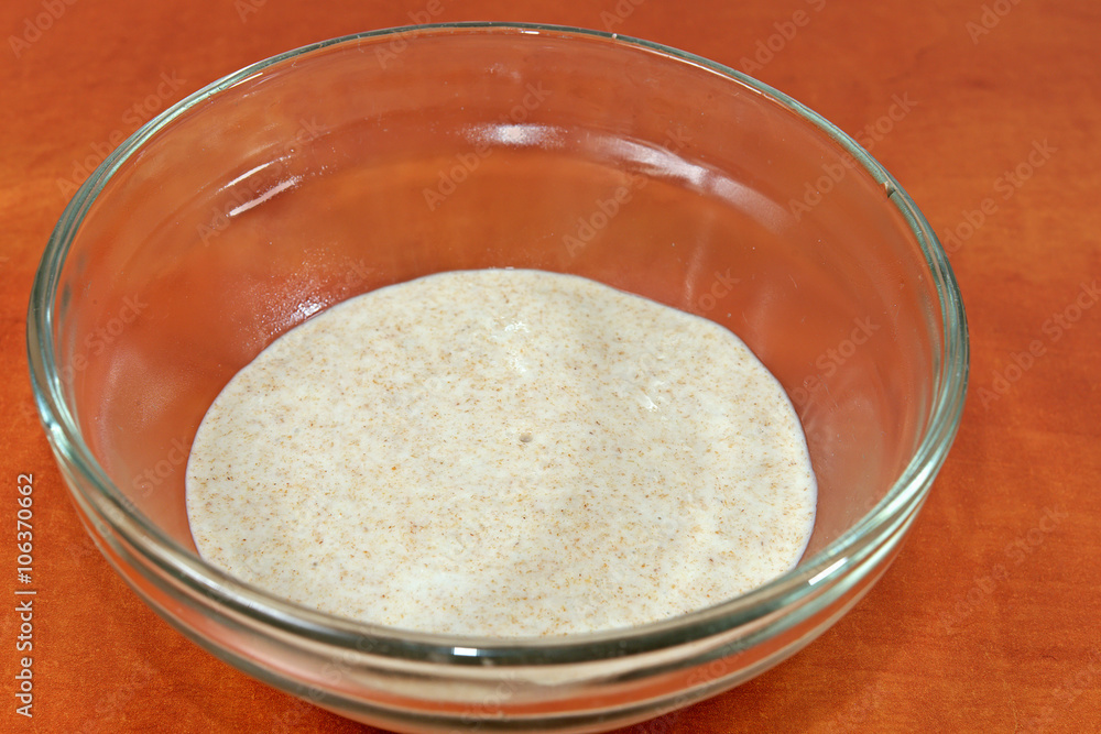 Detail of homemade yeast in a glass bowl Detail of homemade yeast in a glass bowl