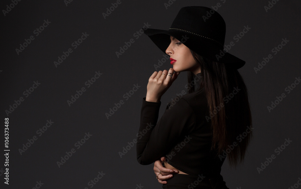 Fashion portrait of young beautiful woman model in casual wear. Black boots, hat and black dress. Copy space. Fashion portrait of young beautiful woman model in casual wear. Black boots, hat and black dress. Copy space.