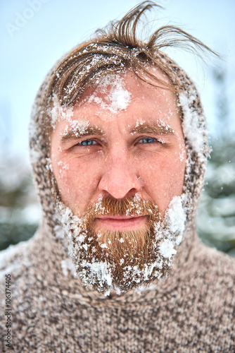 Fotografie Portrait of bearded man with snow on his face