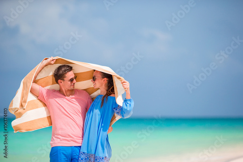 Young happy family during tropical beach vacation
