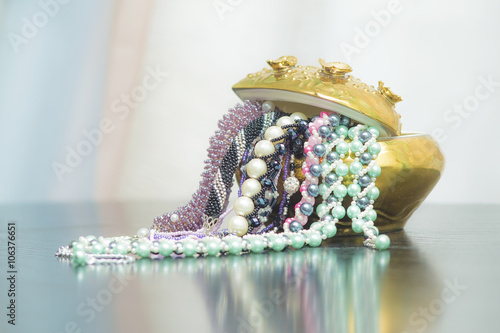 Obraz na plátně Bunch of beaded jewelry in a vase