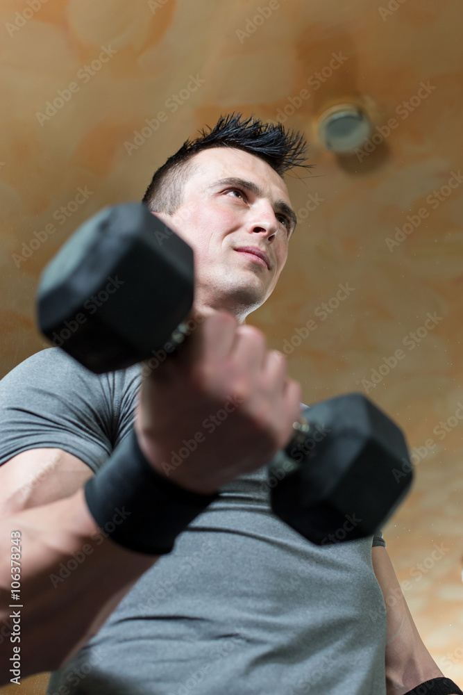 Young Man Working Out Biceps - Dumbbell Concentration Curls