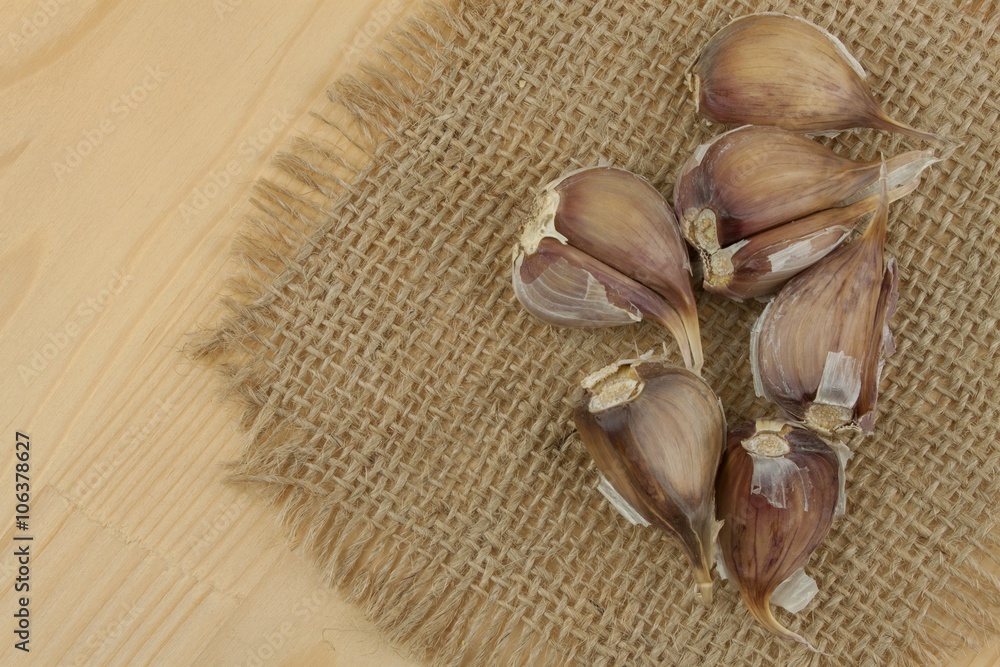 Fresh garlic on a wooden background. Traditional aromatic ingredients in food. Prevention against bad colds and flu.
