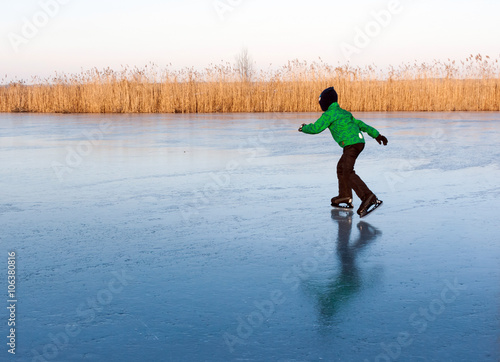 a boy skating on the frozen river