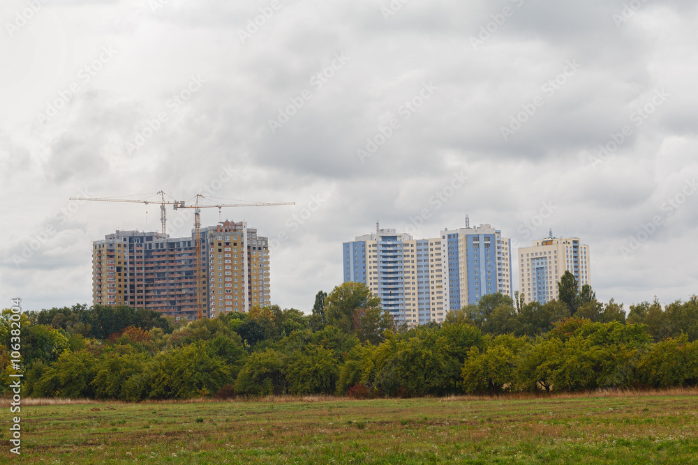 City park and high-rise buildings under construction. Urban City park and high-rise buildings under construction. Urban