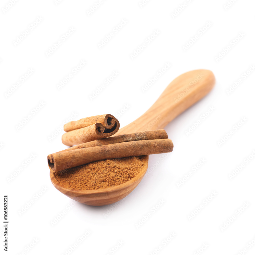 Wooden spoon full of cinnamon