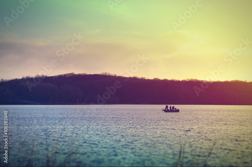 Fishermen on a boat at Lake McBride after sunset