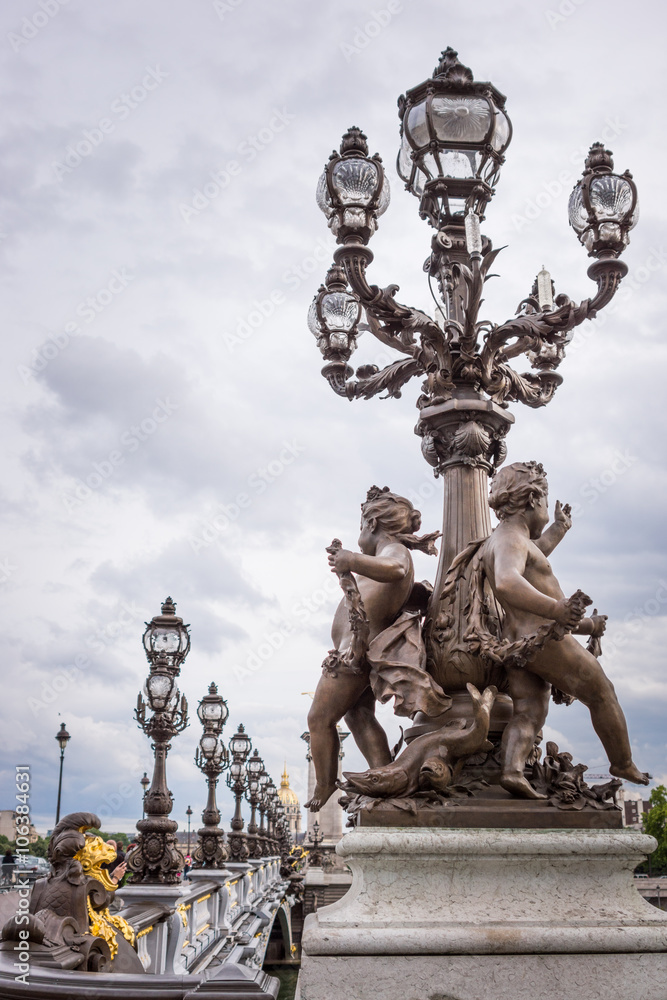 Pont Alexandre III bridge Paris with cherubs statue and lanterns