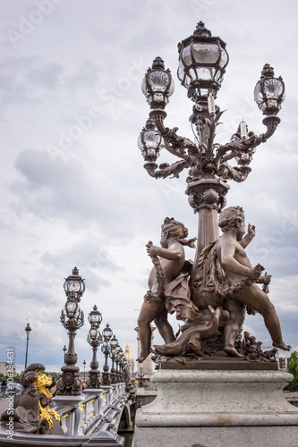 Pont Alexandre III bridge Paris with cherubs statue and lanterns © bellass