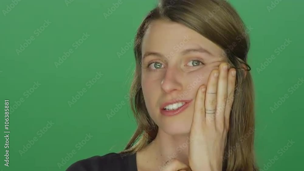 Young woman makes funny faces, on a green screen studio background Young woman makes funny faces, on a green screen studio background