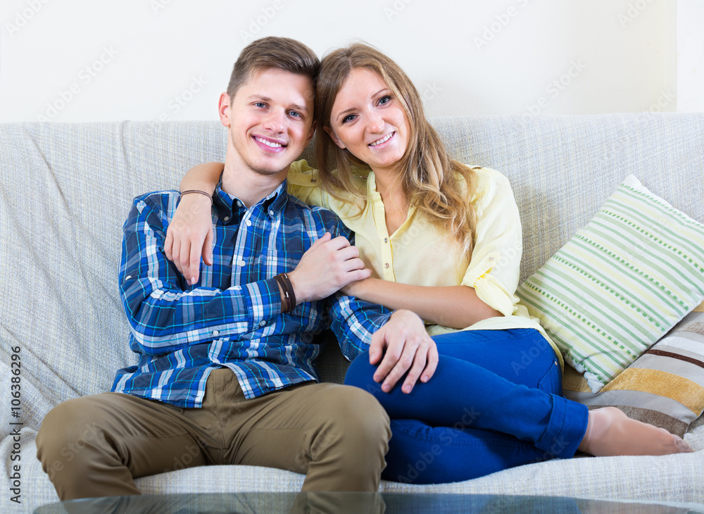 woman and man sitting on couch