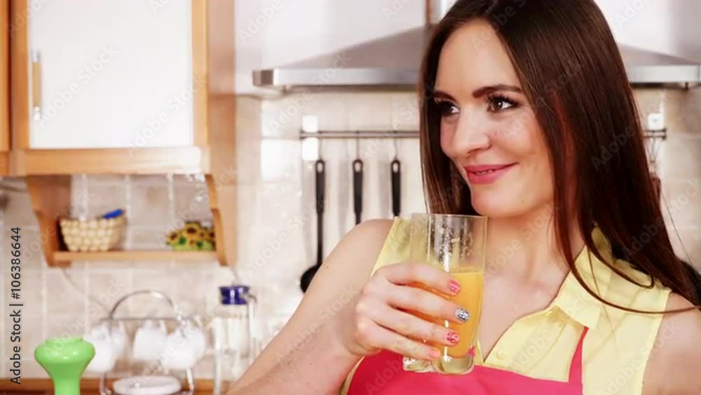Woman in kitchen drinking fresh orange juice 4K Woman in kitchen drinking fresh orange juice 4K