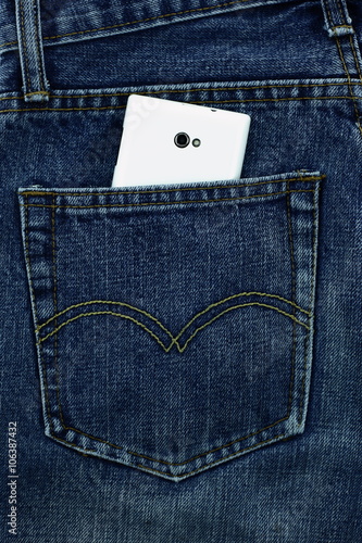 Little box with copy space to add text in the back pocket of blue jeans