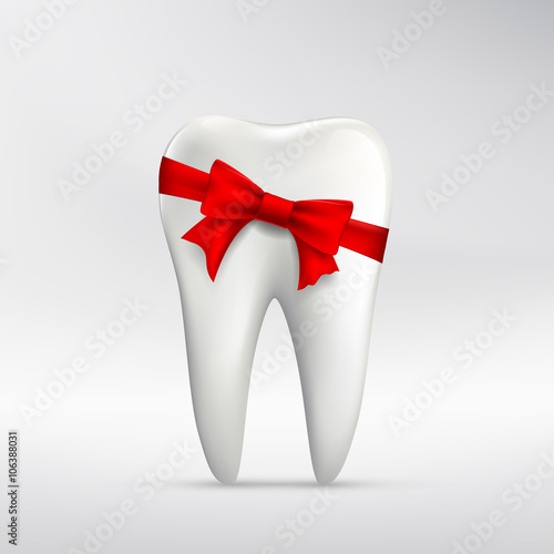 Human tooth with red ribbon