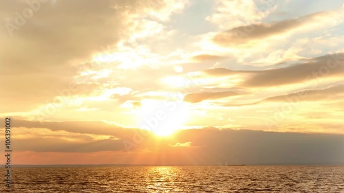 time lapse the sun through the clouds over the sea.