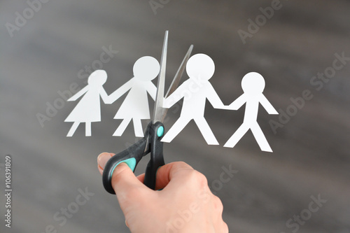 Family divorce concept with human paper shapes and scissors suggesting relationship problems