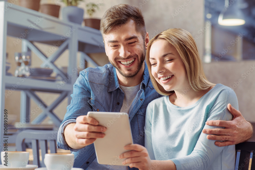 Fototapeta premium Cheerful couple sitting at the table 