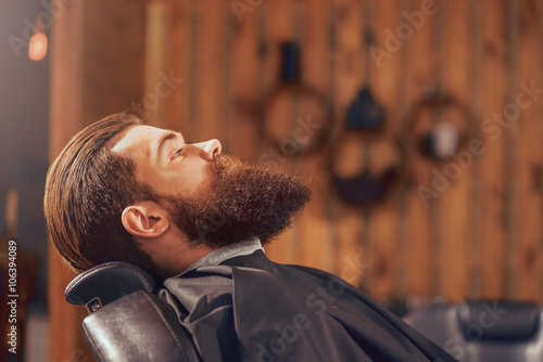 Pleasant man sitting in the barbershop