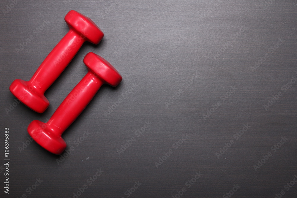 Red dumbbell, fitness concept, top view Red dumbbell, fitness concept, top view