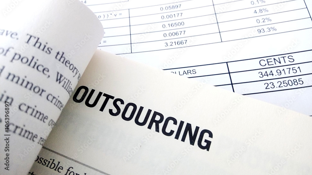 Obraz premium Outsourcing word on book