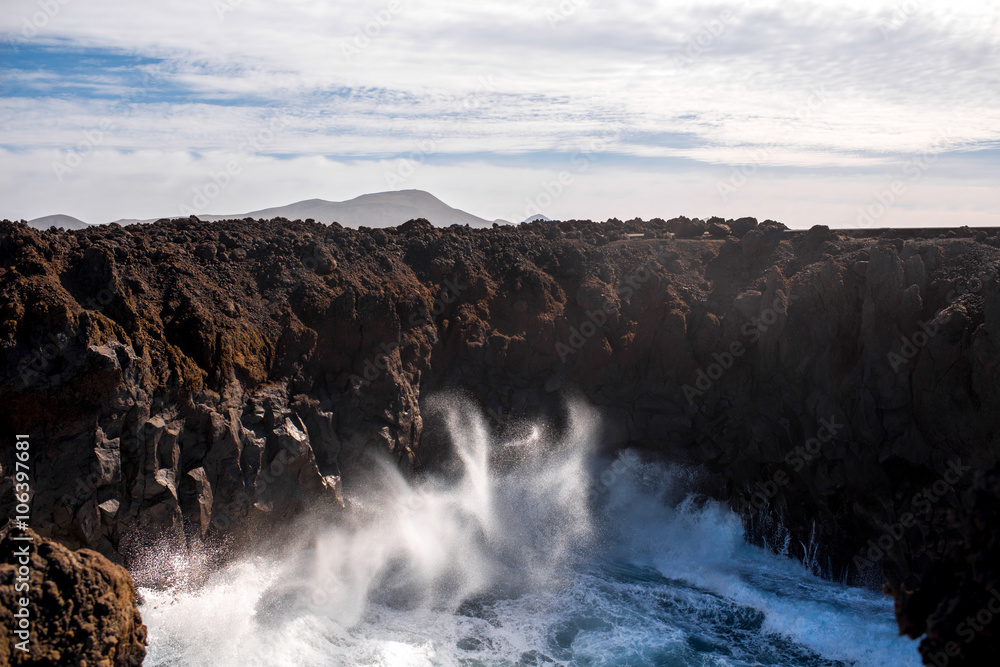 Huge ocean splash on the rocky Los Hervideros coast on Lanzarote island in Spain