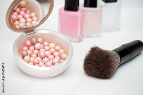 cosmetic brush and pastel rouge on white background