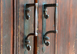 Old doorknobs, doorknockers and handles on ancient doors