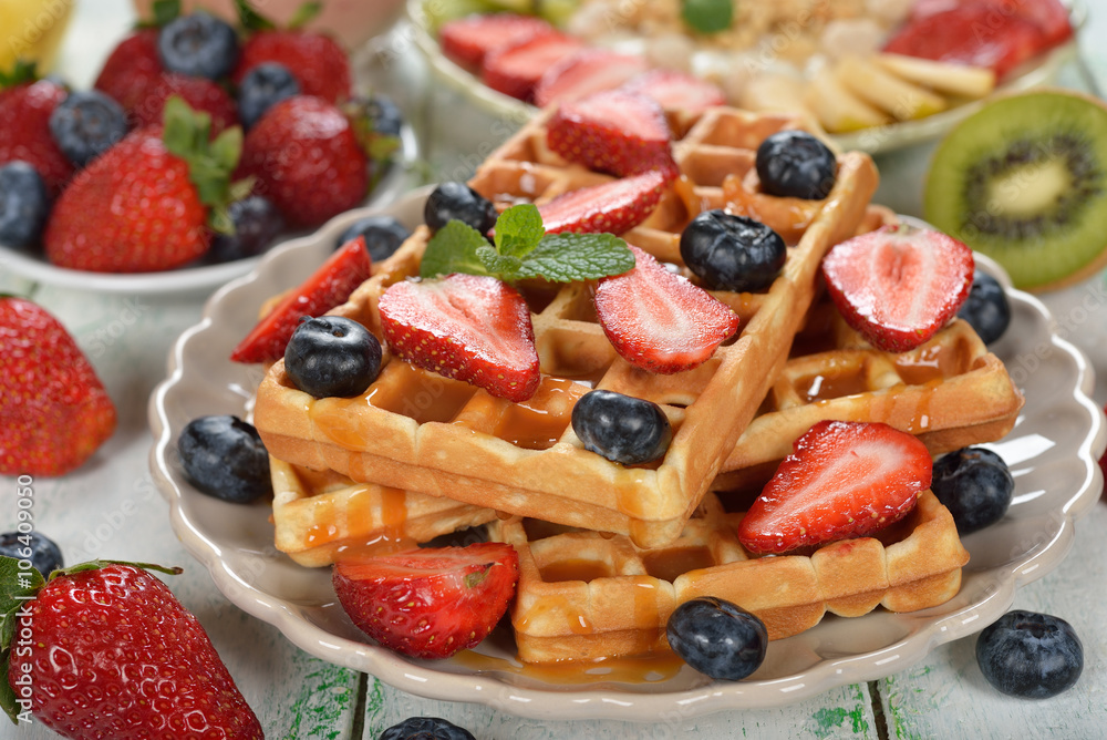 Waffles with berries and caramel sauce
