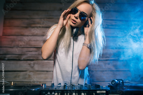 Fotografie Cute dj woman having fun playing music at club party