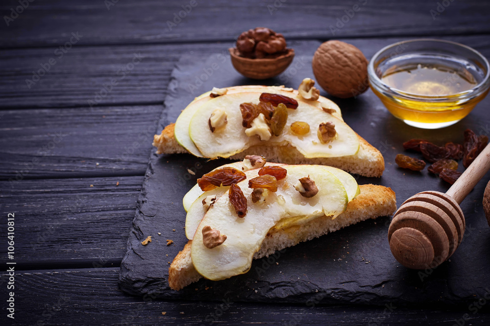 Fototapeta premium Toasts with apple, walnuts, raisin and honey