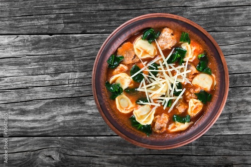 tortellini soup with italian sausages, spinach, tomato, parmesan cheese , top-view
