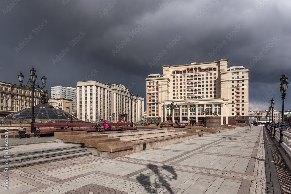 Moscow, Russia - March 20, 2016: View of the Manezhnaya Square and the State Duma against dark thunderclouds.