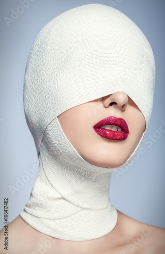 Beautiful woman after plastic surgery with bandaged face