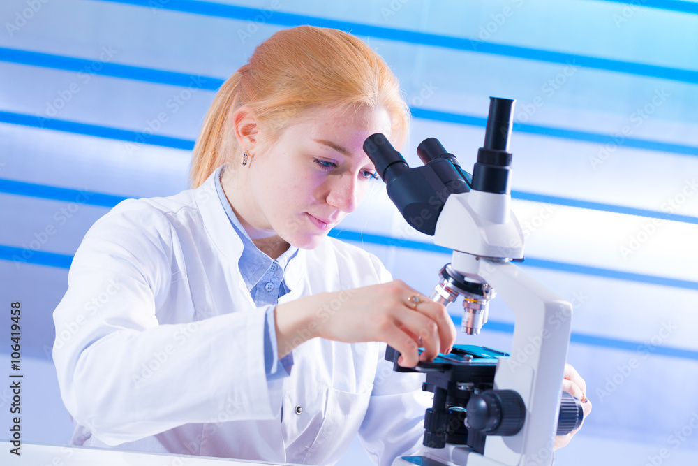 Young technician look at science microscope Young technician look at science microscope