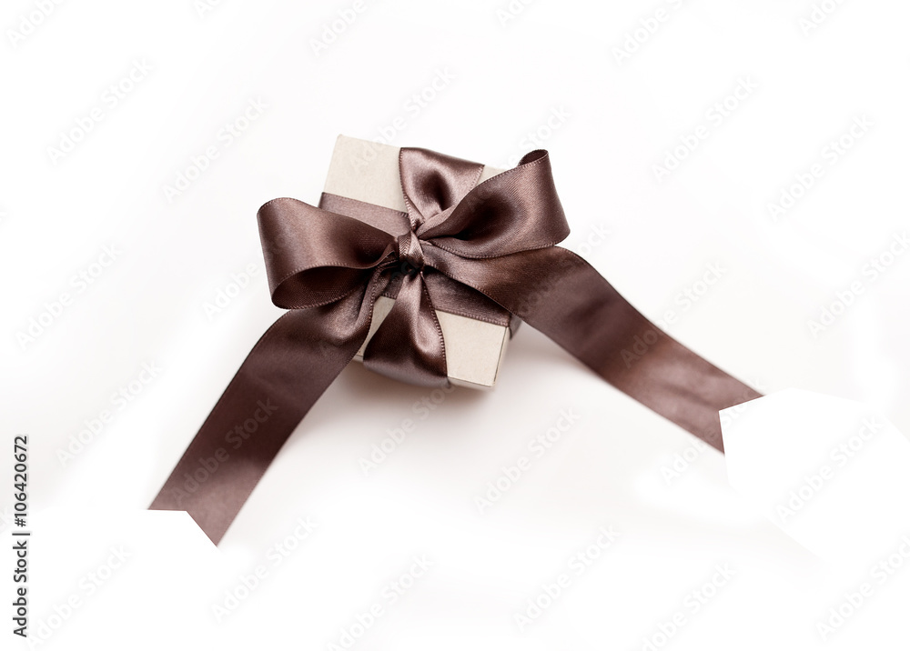 Gift box with brown bow on a white background Gift box with brown bow on a white background
