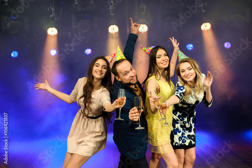 cheerful young company celebrates birthday in a nightclub