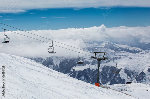 Beautiful blue skies with clouds over the mountains in the snow. Winter landscape