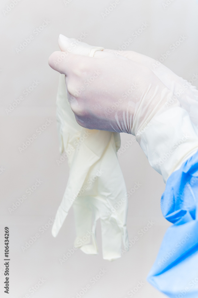 Fototapeta premium Doctor puts on surgical gloves