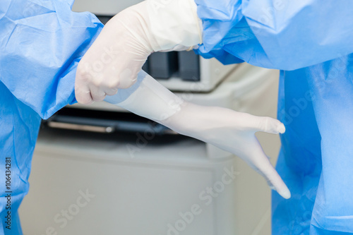 Doctor puts on surgical gloves