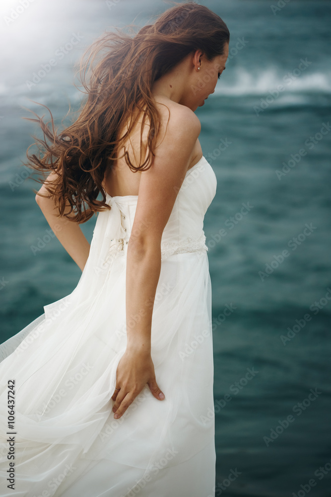 Woman in White near Stormy Sea Woman in White near Stormy Sea