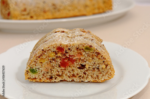 Homemade fruitcake with candied fruit on a white plate