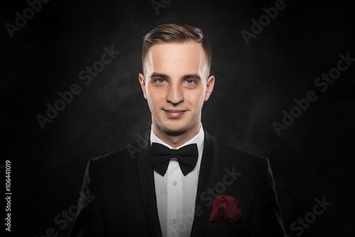 Young handsome man in black suit. © Denis Rozhnovsky